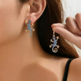 Gecko-korvakorut onnenamuletin kanssa – ilmainen sormus | Rajoitettu tarjous